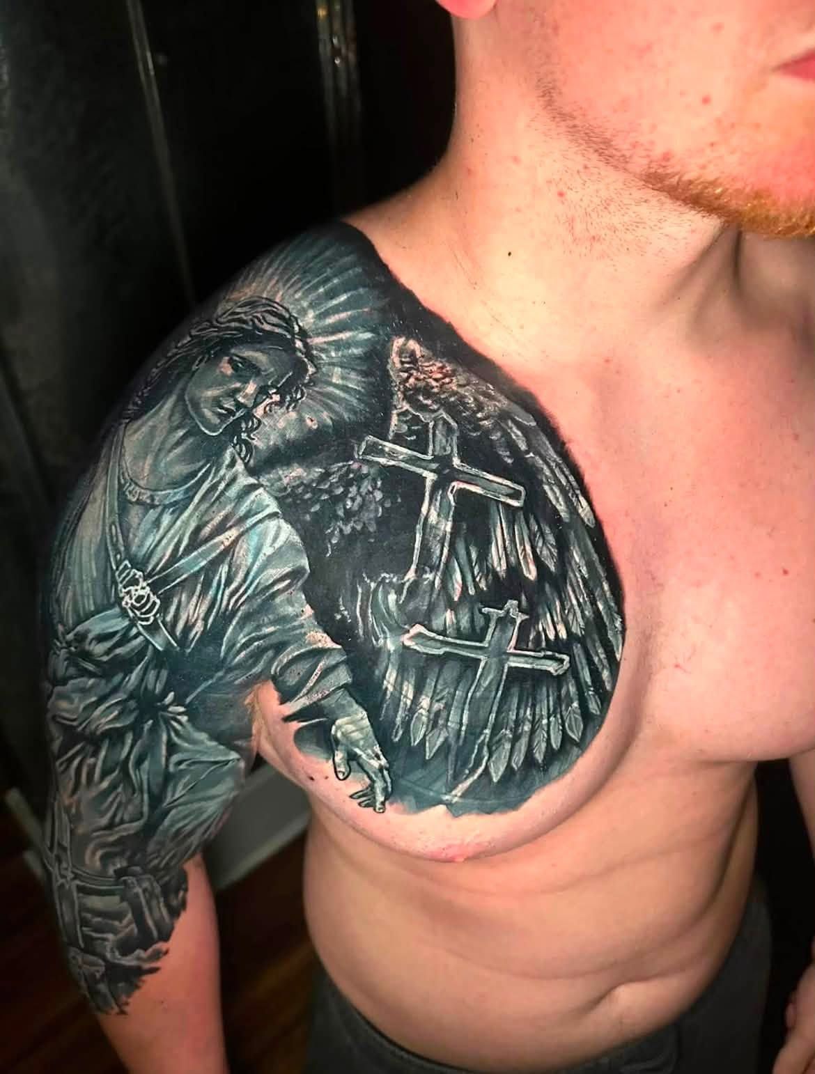 Black and grey chest and shoulder piece with wings and architectural detail.